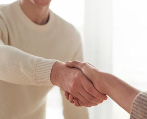 A man and woman shaking hands after a job interview,