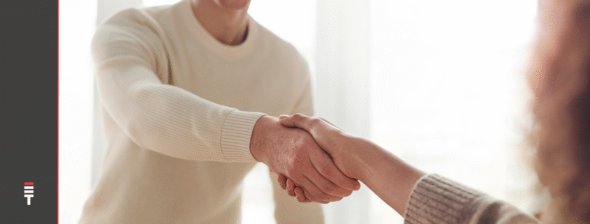 A man and woman shaking hands after a job interview,