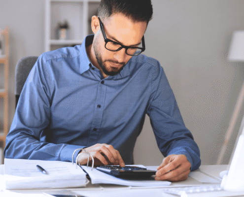 A man sitting at a desk deciding on a direct hire vs. contract job model.