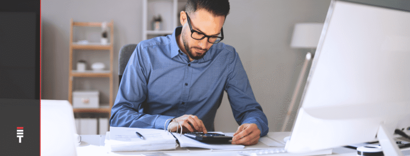 A man sitting at a desk deciding on a direct hire vs. contract job model.