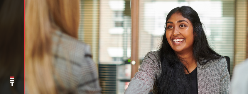 A woman in an interview answering "What are you looking for a new position?"